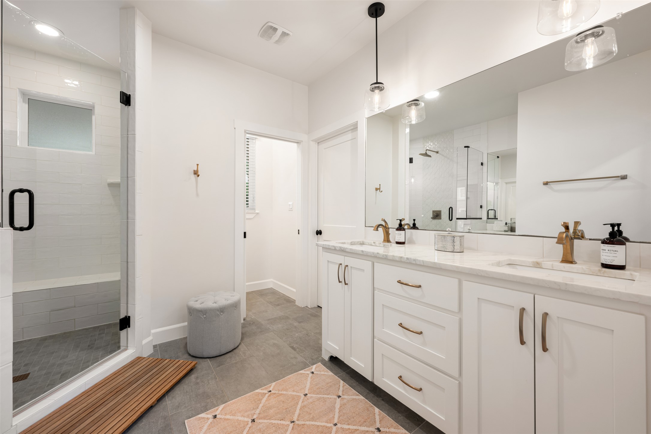 1301 West Street Georgetown, TX 78626 - Photo 21 of 40 Marble countertops adorn the dual vanity in this pristine, naturally illuminated bathroom.