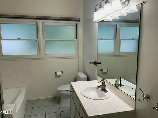 a bathroom with a sink toilet and a mirror