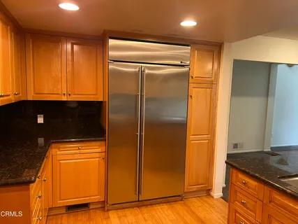a kitchen with a refrigerator and cabinets