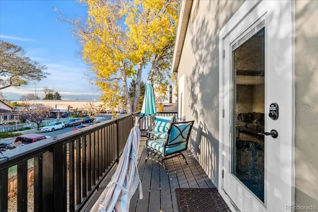 a view of a balcony with wooden floor and fence