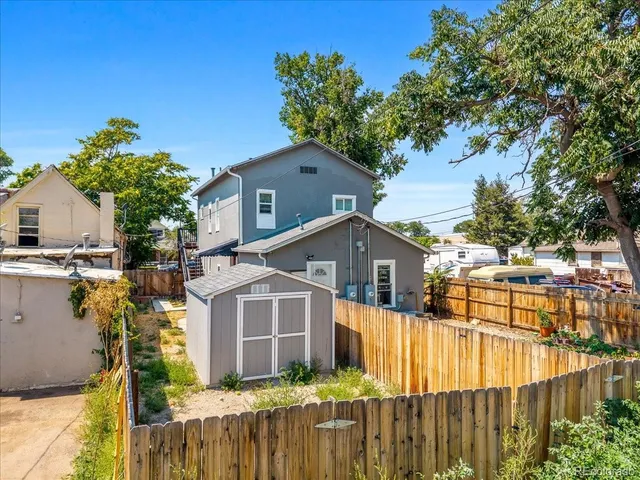 a view of a house with wooden fence