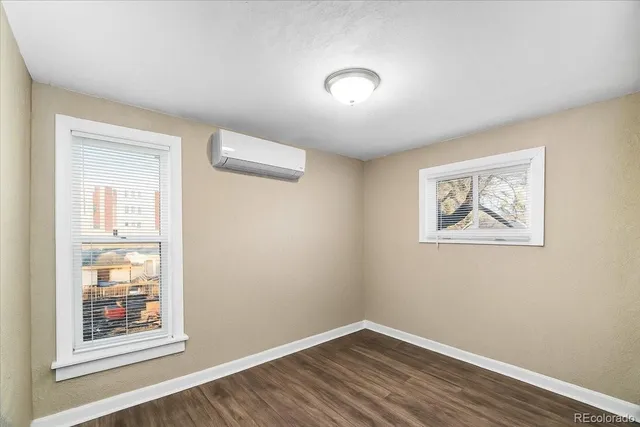 a view of a hallway with wooden floor and closet