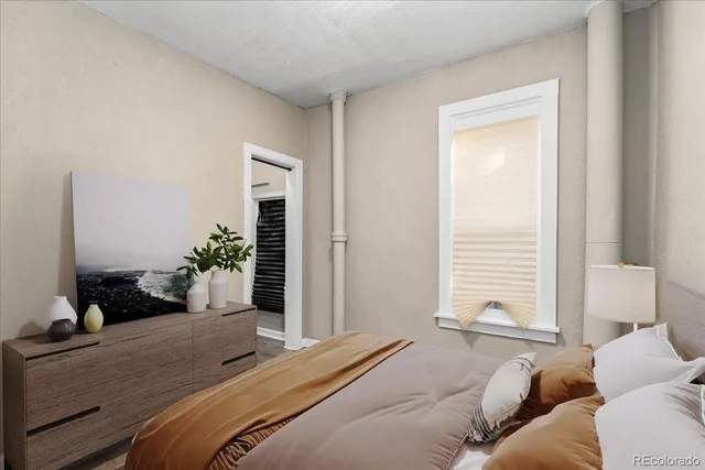 a bedroom with a bed and windows