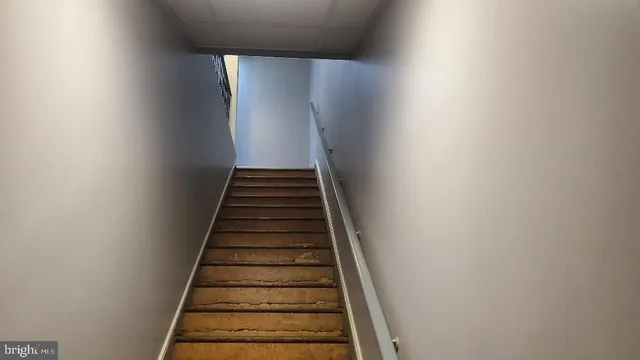 a view of a hallway with wooden floor and entryway