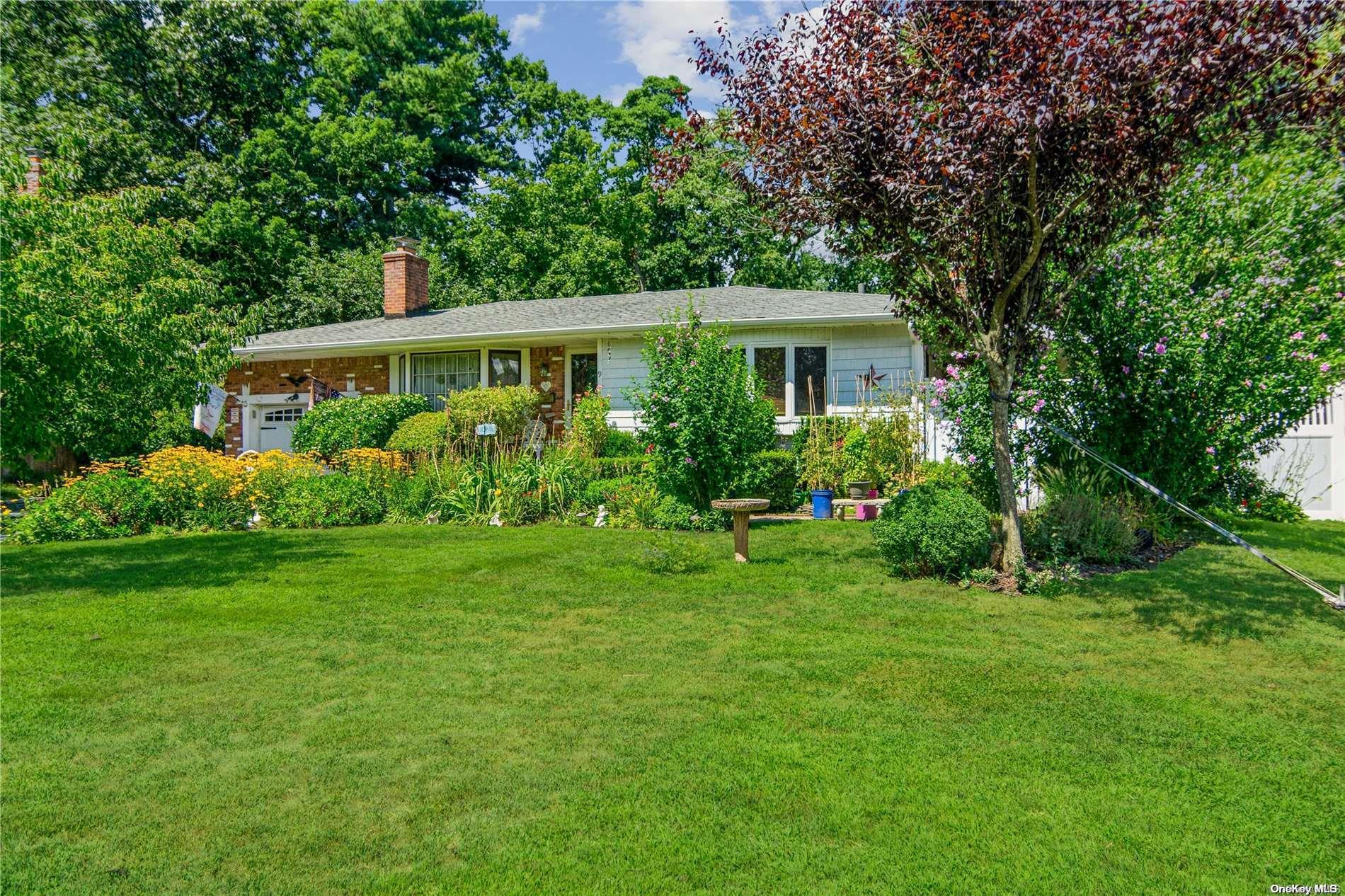 9 Evon Lane St. James, NY 11780 - Photo 1 of 1 a front view of house with yard and green space