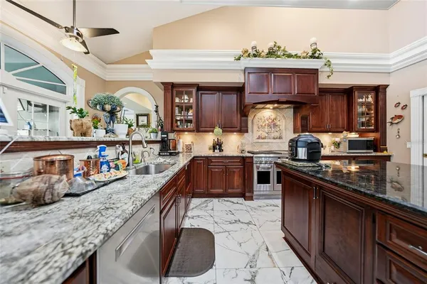 a kitchen with stainless steel appliances granite countertop a stove and cabinets