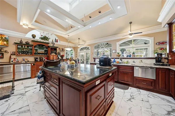 a kitchen with stainless steel appliances granite countertop a sink and a stove