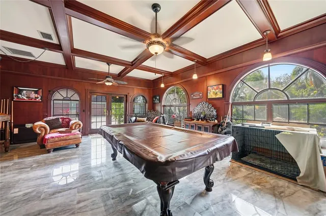 a bathroom with a granite countertop tub a double vanity sink and a window