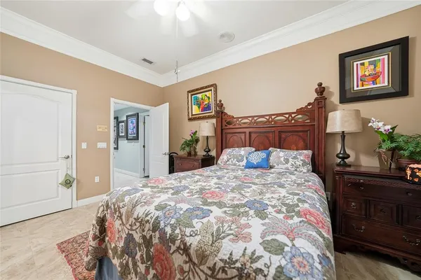 a bedroom with a bed and a painting on the wall