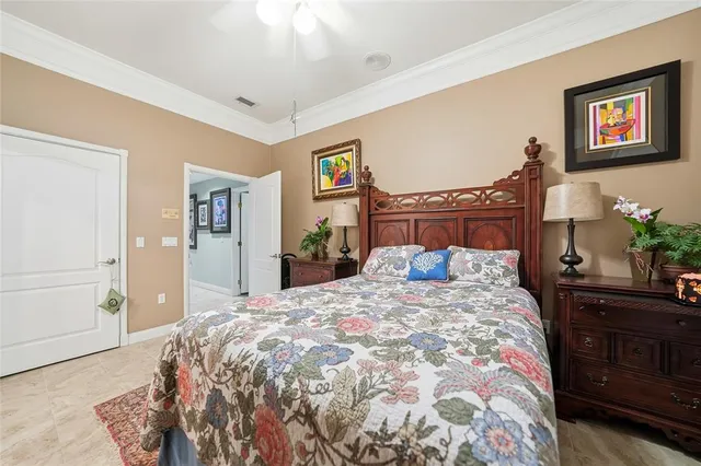 a bedroom with a bed and a painting on the wall