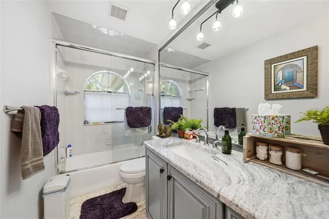 a bed room with furniture and a flat screen tv