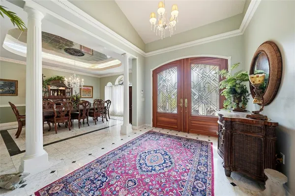 a living room with furniture and a chandelier