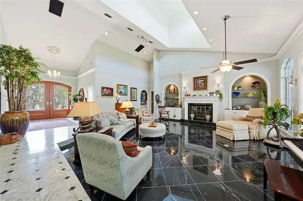a living room with fireplace furniture and a chandelier