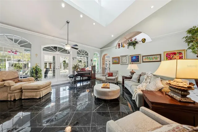 a living room with furniture and a chandelier
