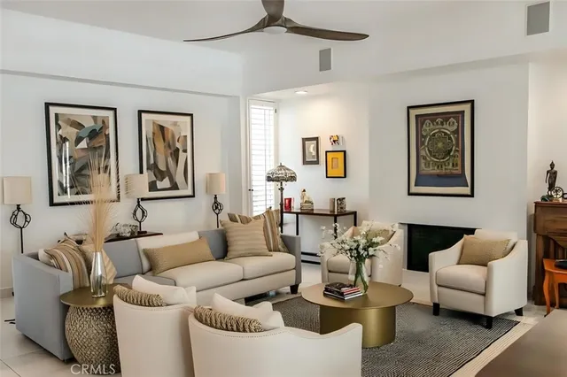 a living room with furniture and painting on the wall