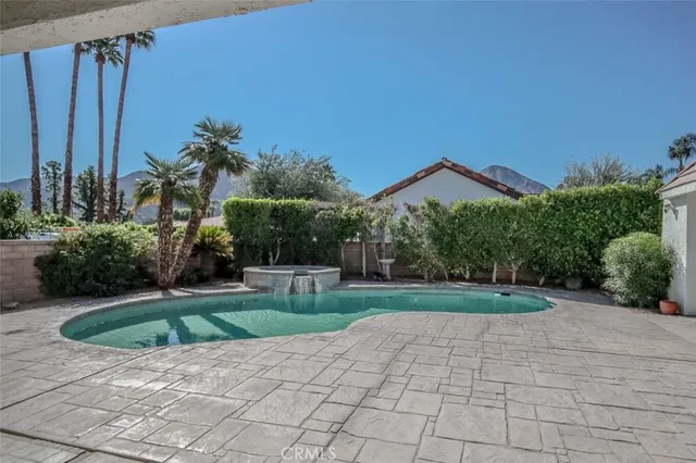 a view of a house with a yard and potted plants