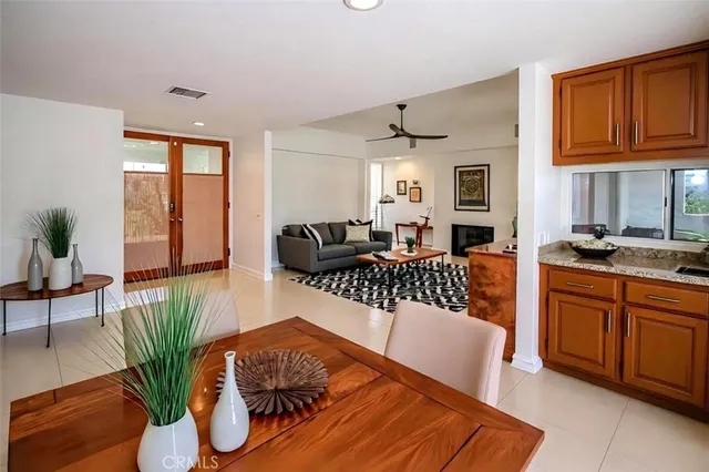 a living room with furniture a fireplace and a potted plant