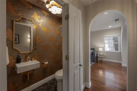 a bedroom with a large bed a flat tv screen and a fireplace