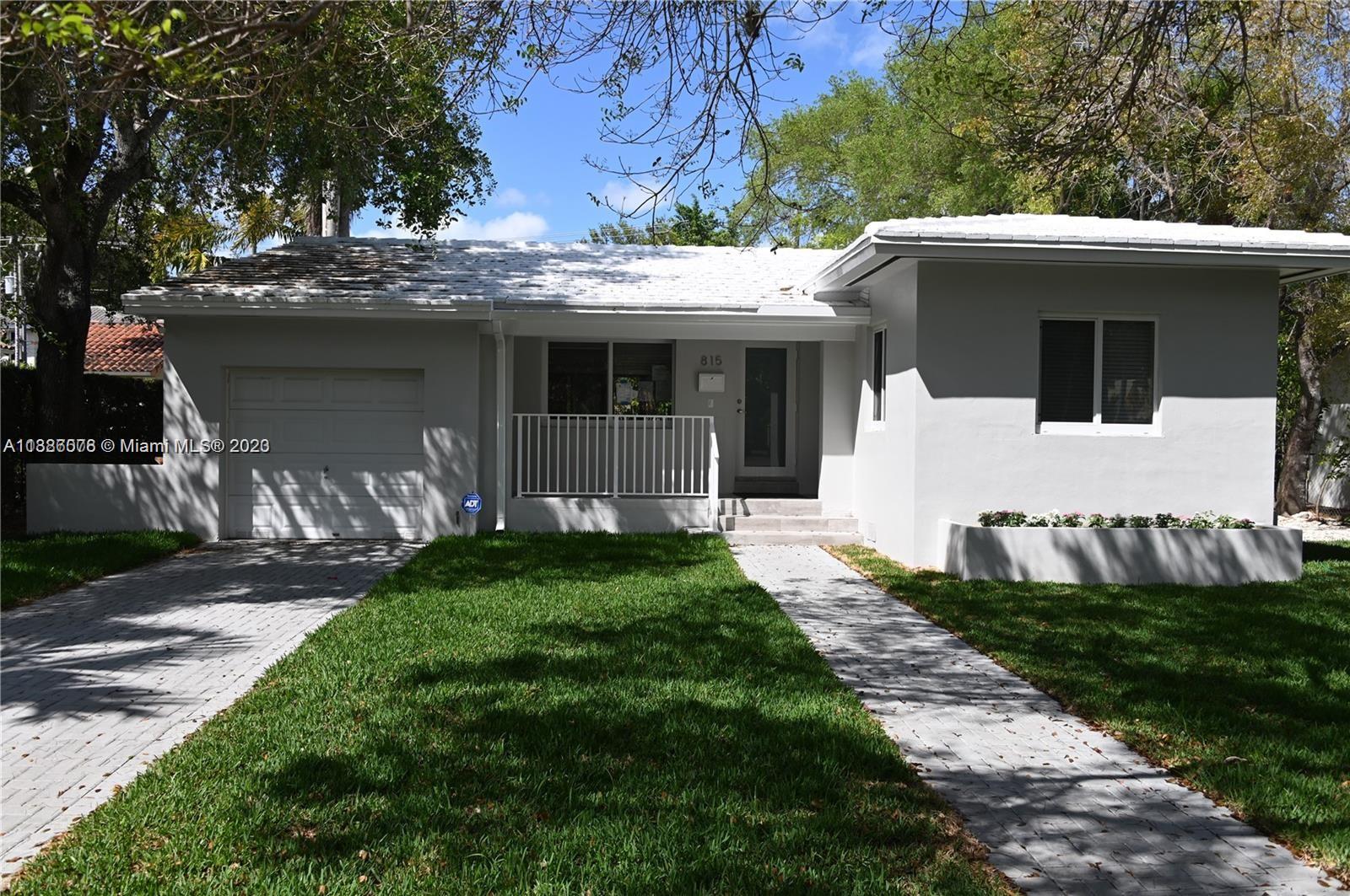 Granada Coral Gables, FL 33134 - Photo 13 of 13 a front view of a house with a garden