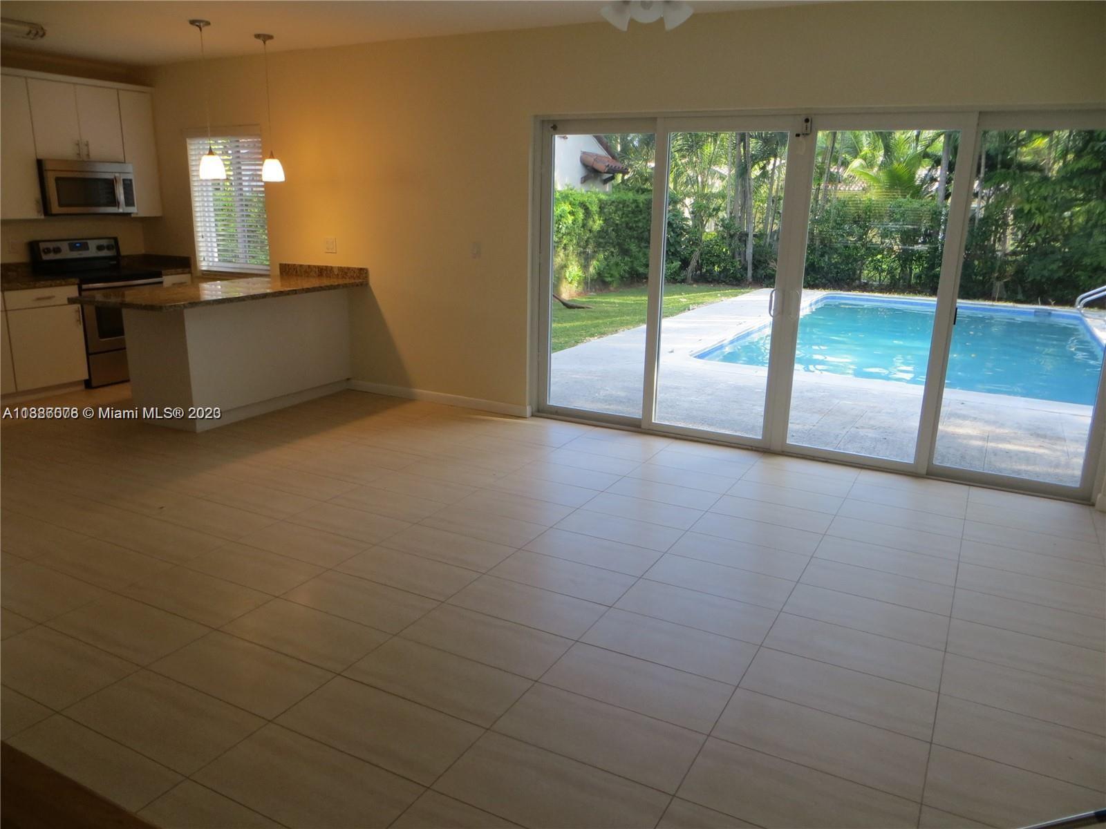 Granada Coral Gables, FL 33134 - Photo 4 of 13 a view of empty room with wooden floor and fan