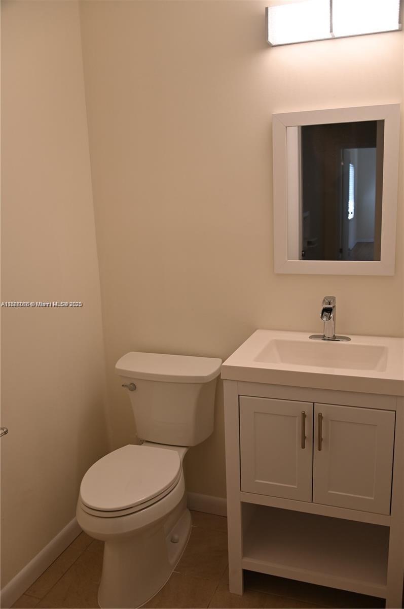 Granada Coral Gables, FL 33134 - Photo 10 of 13 a bathroom with a toilet sink and mirror