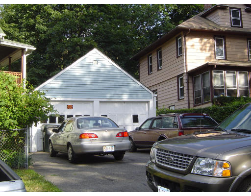 91-93 Orange Street Springfield, MA 01108 - Photo 5 of 17 a front view of a house with parking space