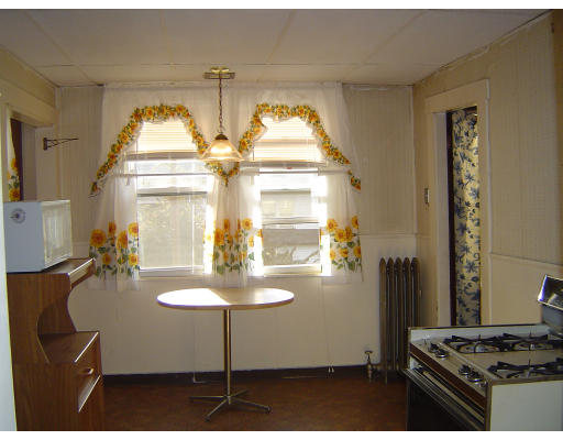 91-93 Orange Street Springfield, MA 01108 - Photo 10 of 17 a kitchen with stainless steel appliances granite countertop a stove and a dining table
