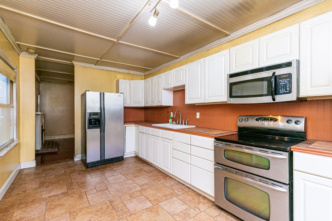 298 Franklin Road Lebanon, TN 37087 - Photo 22 of 34 a kitchen with stainless steel appliances granite countertop a stove a refrigerator and a microwave