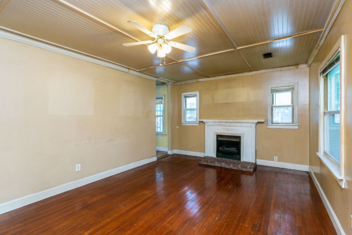 298 Franklin Road Lebanon, TN 37087 - Photo 8 of 34 an empty room with wooden floor fireplace and windows