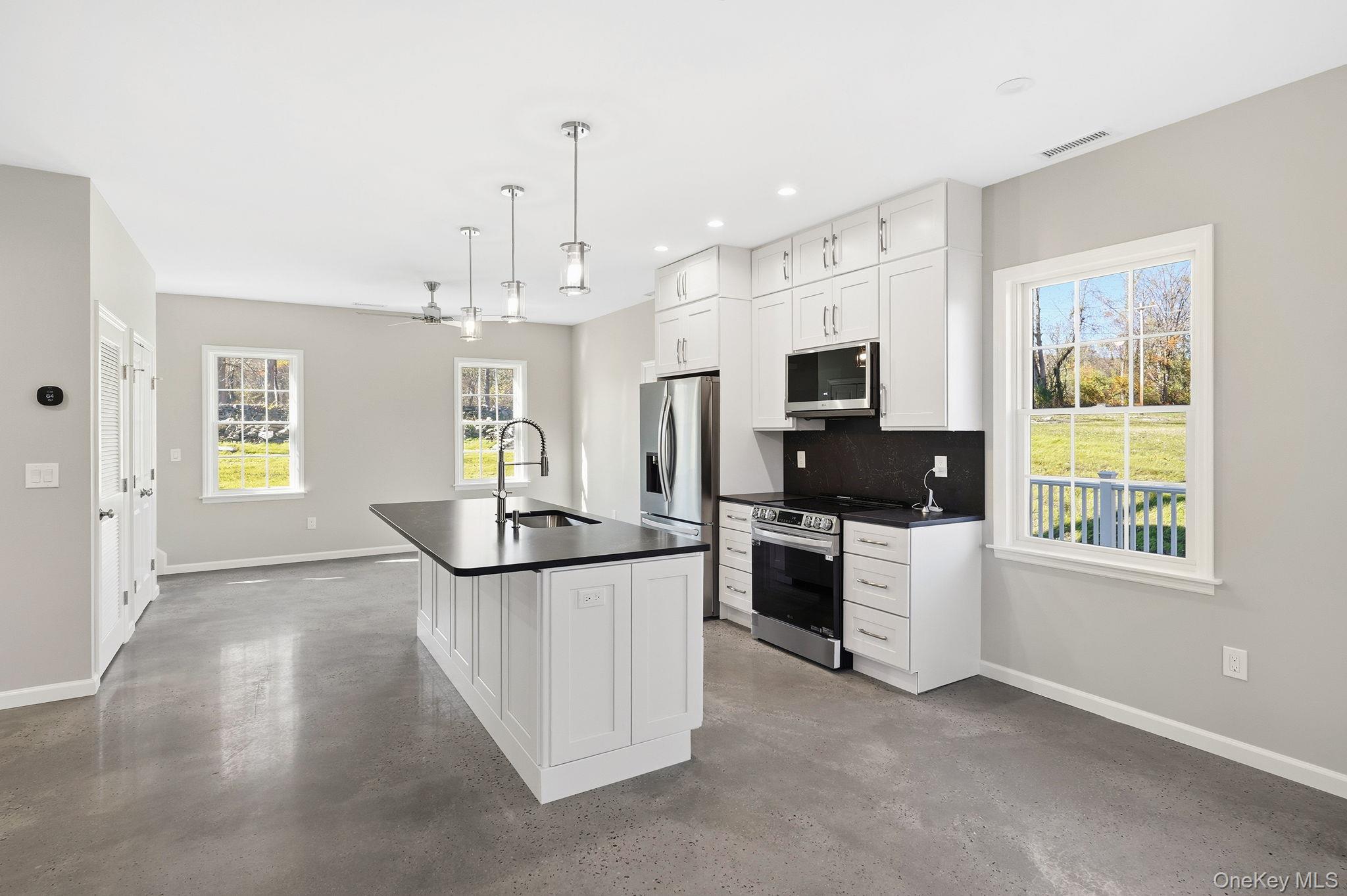 40 Cushman Road Patterson, NY 12563 - Photo 14 of 40 a kitchen with granite countertop a sink and steel appliances