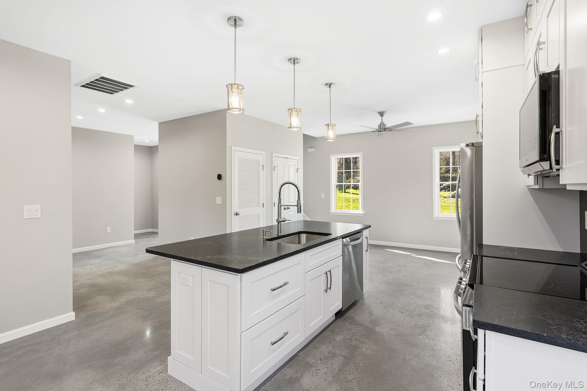 40 Cushman Road Patterson, NY 12563 - Photo 15 of 40 a kitchen with stainless steel appliances granite countertop a sink a stove and a refrigerator