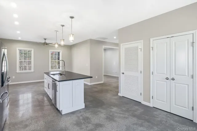 a kitchen with stainless steel appliances granite countertop a sink refrigerator and microwave