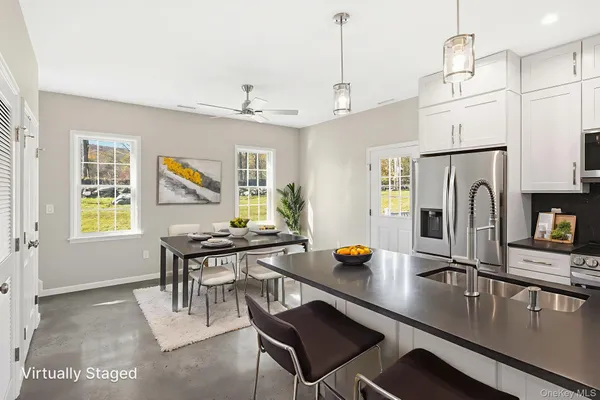 a kitchen with granite countertop a sink and steel appliances