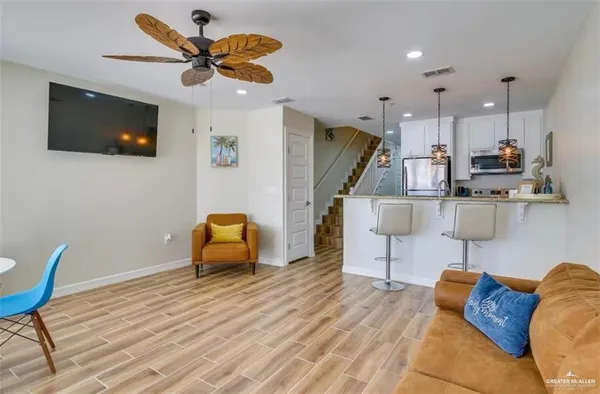 a living room with furniture and a flat screen tv
