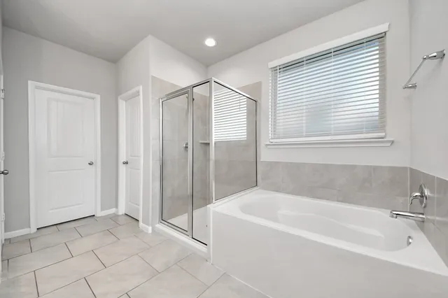 a spacious bathroom with a bathtub and a shower
