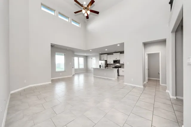 a view of empty room with wooden floor and window
