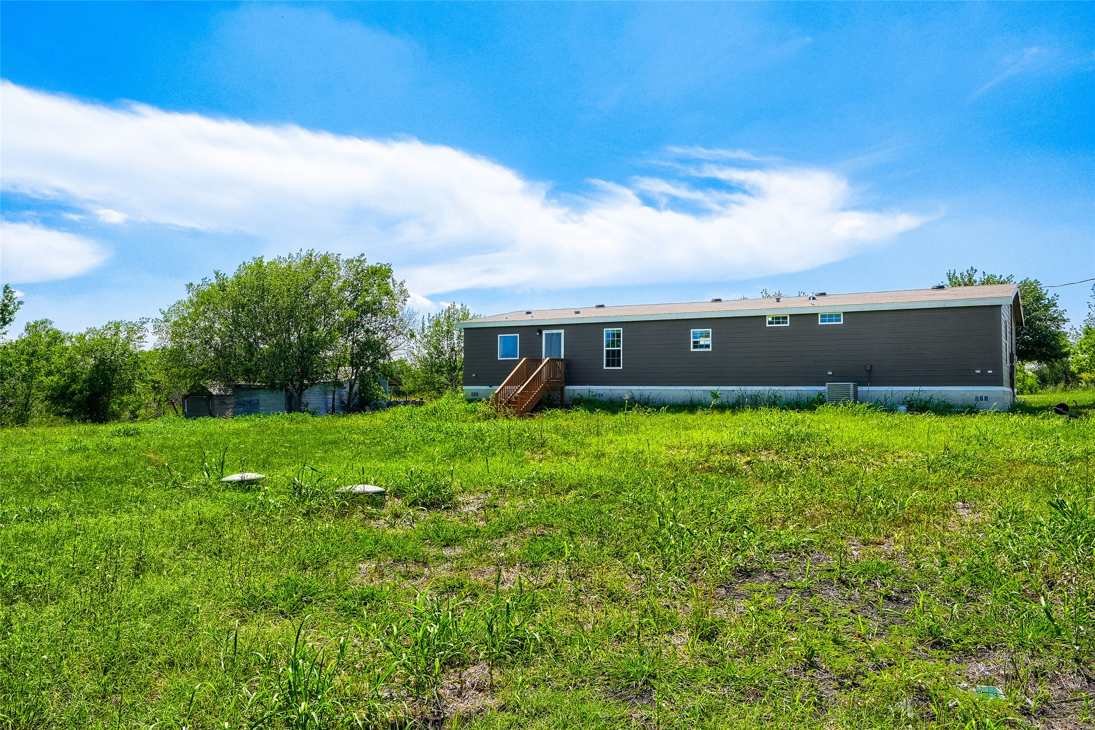 401 Graef Road Kyle, TX 78640 - Photo 25 of 30 A spacious, verdant lot awaits your vision, ready for outdoor enjoyment and expansion.