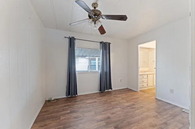 a view of an empty room with a ceiling fan