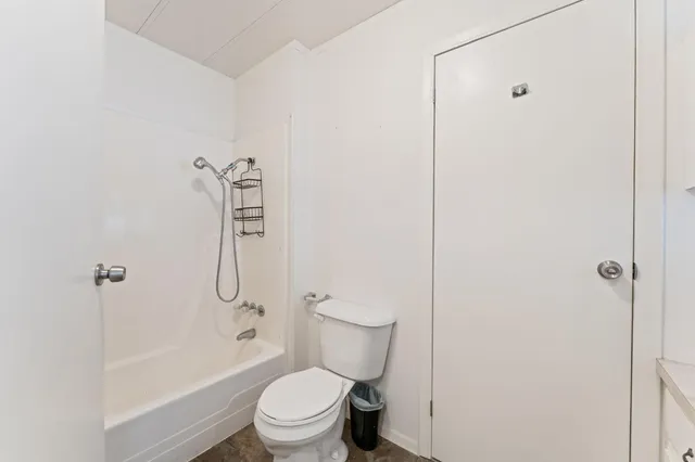 a bathroom with a toilet and shower