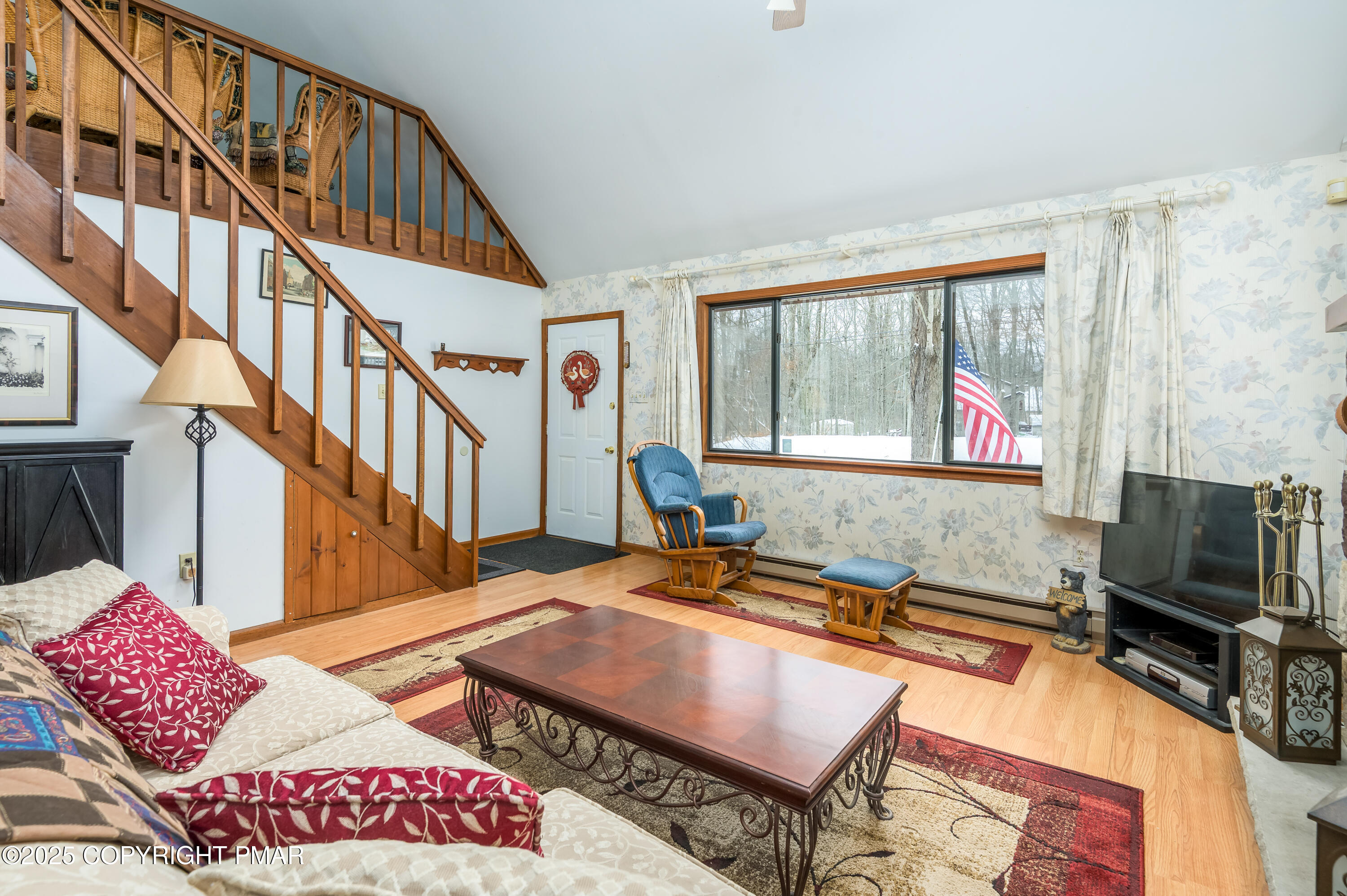 233 Pontiac Path Pocono Lake, PA 18347 - Photo 13 of 46 a living room with furniture a flat screen tv and a window