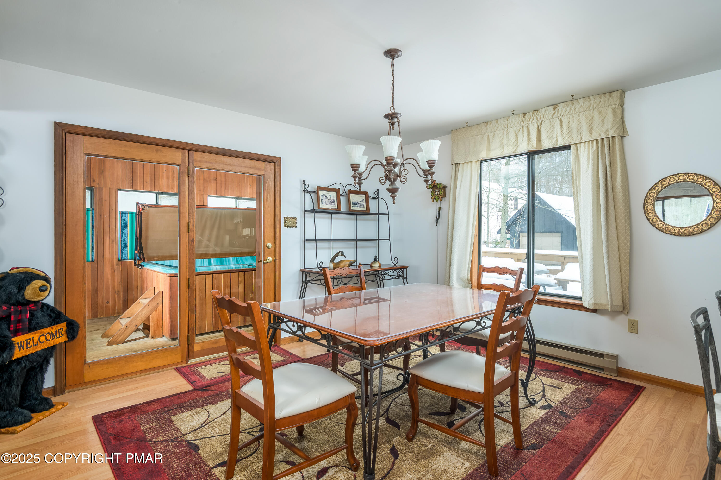 233 Pontiac Path Pocono Lake, PA 18347 - Photo 15 of 46 a dining room with furniture a chandelier and wooden floor