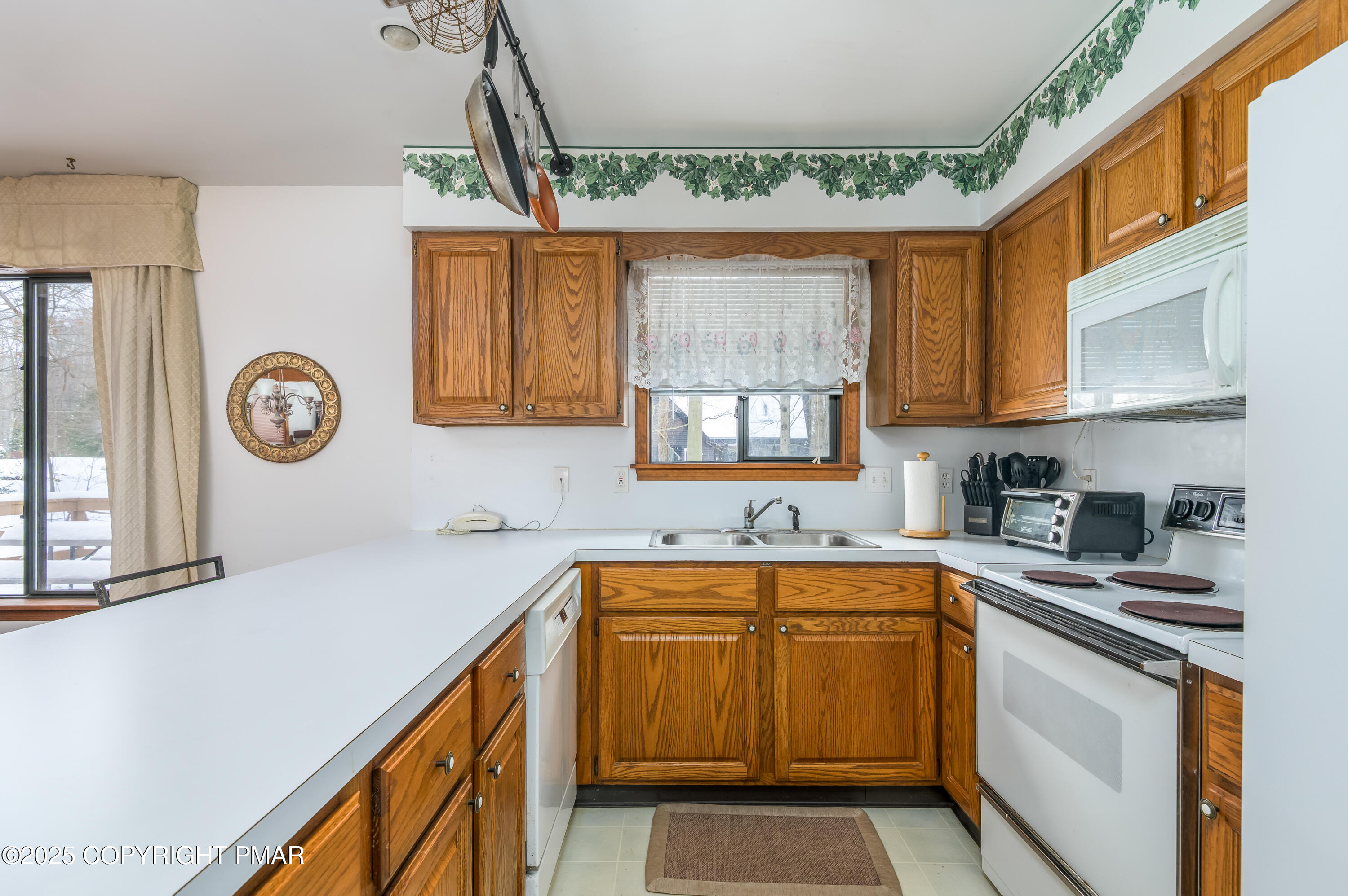 233 Pontiac Path Pocono Lake, PA 18347 - Photo 18 of 46 a kitchen with a sink a stove and cabinets