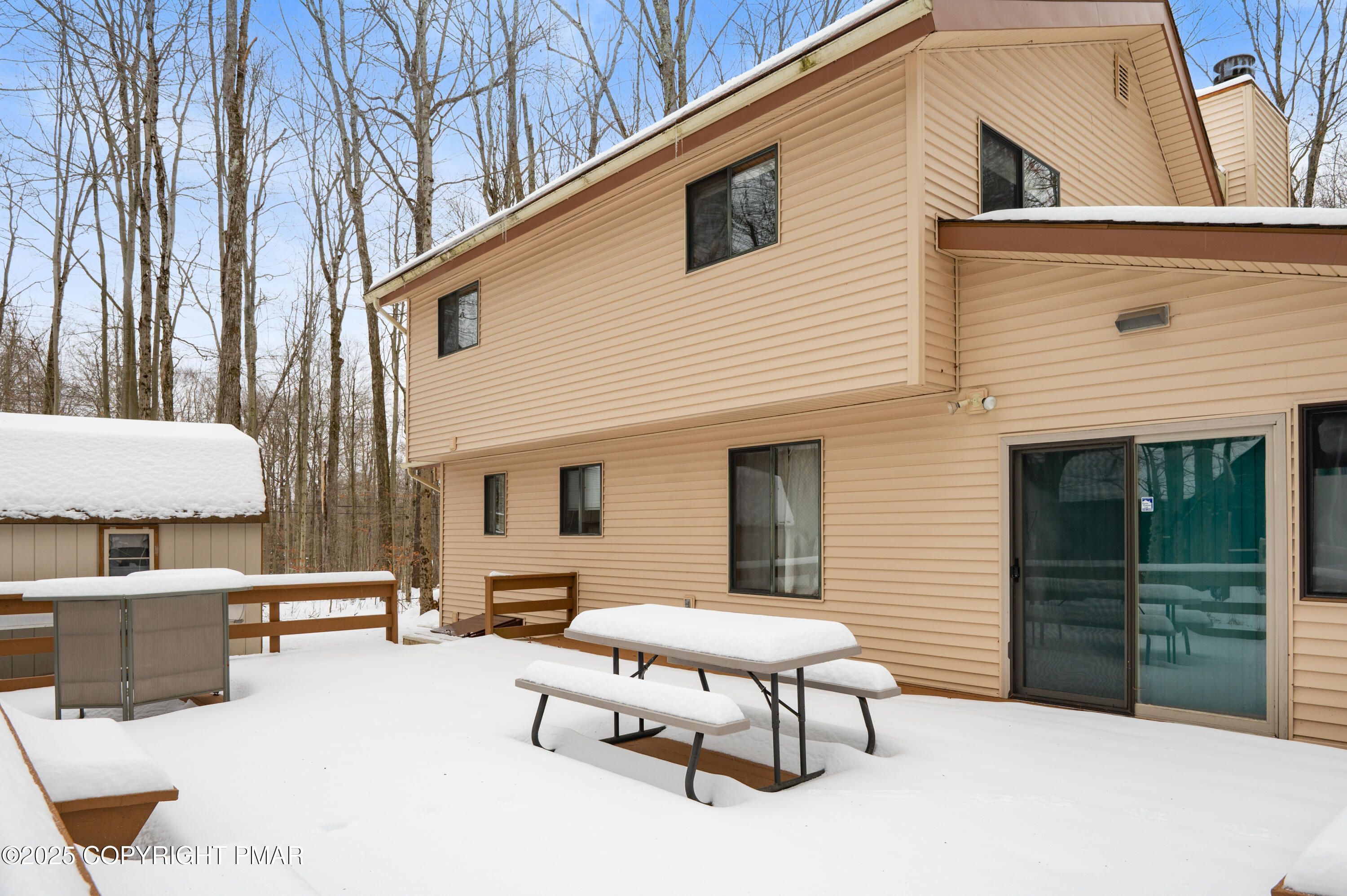 233 Pontiac Path Pocono Lake, PA 18347 - Photo 8 of 46 a backyard of a house with table and chairs