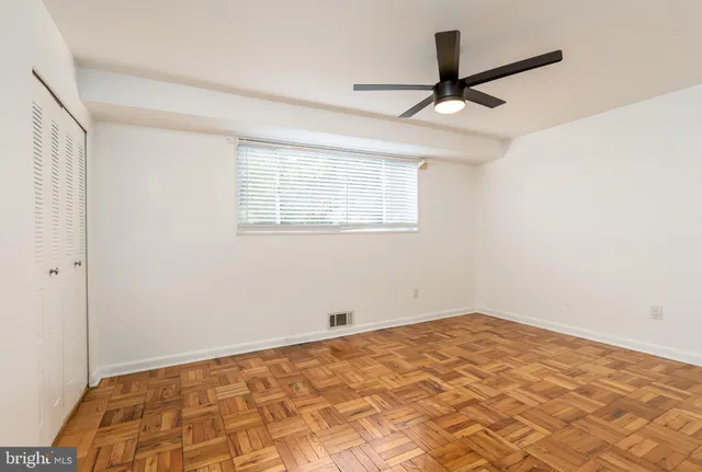 a view of a room with a ceiling fan and a window
