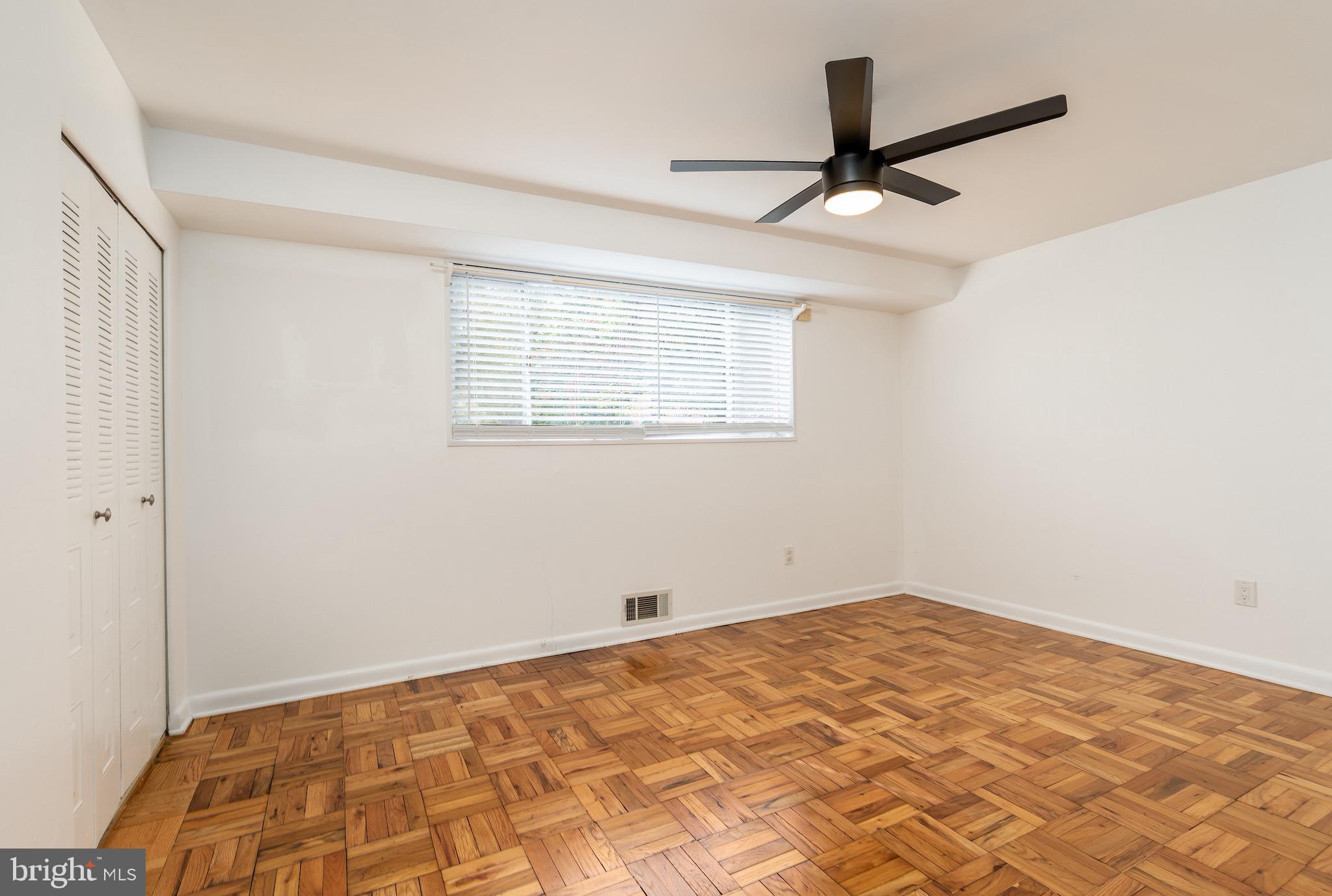 10423 Montrose Avenue, Unit 10423 Bethesda, MD 20814 - Photo 14 of 22 a view of a room with a ceiling fan and a window