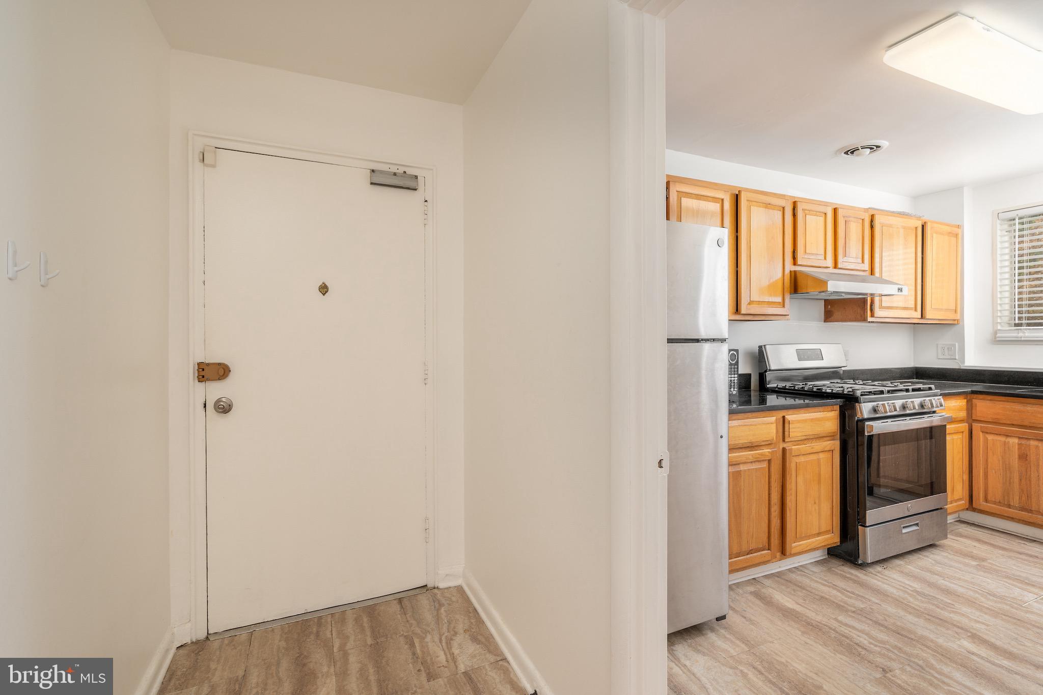 10423 Montrose Avenue, Unit 10423 Bethesda, MD 20814 - Photo 2 of 22 a kitchen with stainless steel appliances granite countertop a refrigerator and a sink