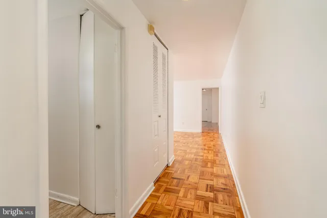 a view of a hallway with white walls