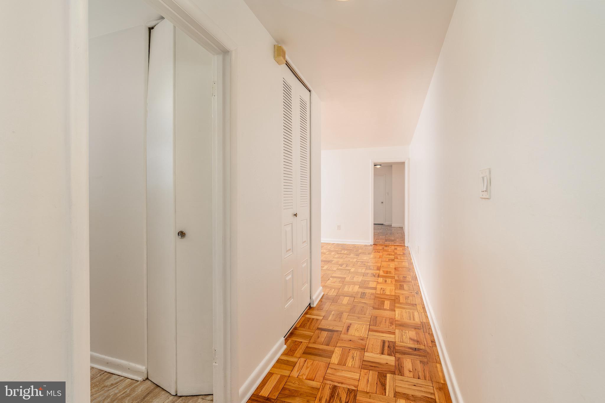 10423 Montrose Avenue, Unit 10423 Bethesda, MD 20814 - Photo 6 of 22 a view of a hallway with white walls