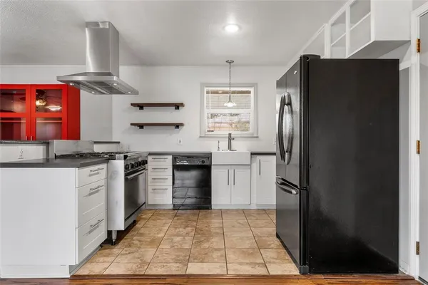 a kitchen with stainless steel appliances granite countertop a refrigerator stove and sink
