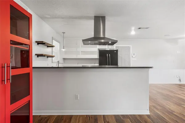 a kitchen with stainless steel appliances granite countertop a sink and a refrigerator